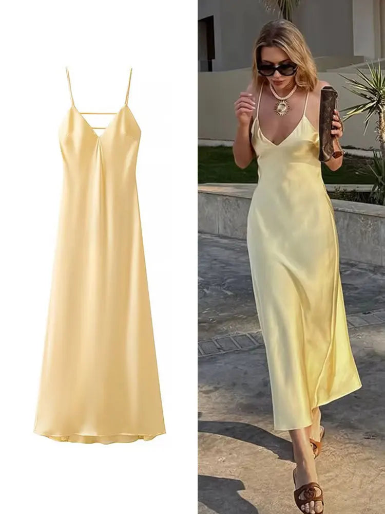 Yellow dress with a V-neck and thin straps, elegant, long, loose-fitting, sleeveless dress, 2025 style, for parties and special occasions.