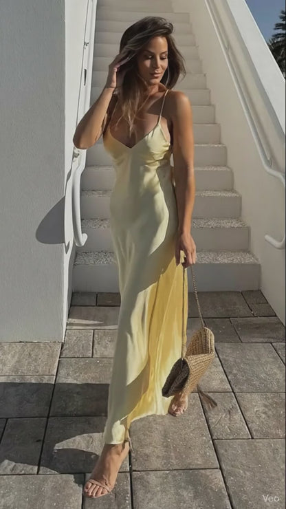 Yellow dress with a V-neck and thin straps, elegant, long, loose-fitting, sleeveless dress, 2025 style, for parties and special occasions.